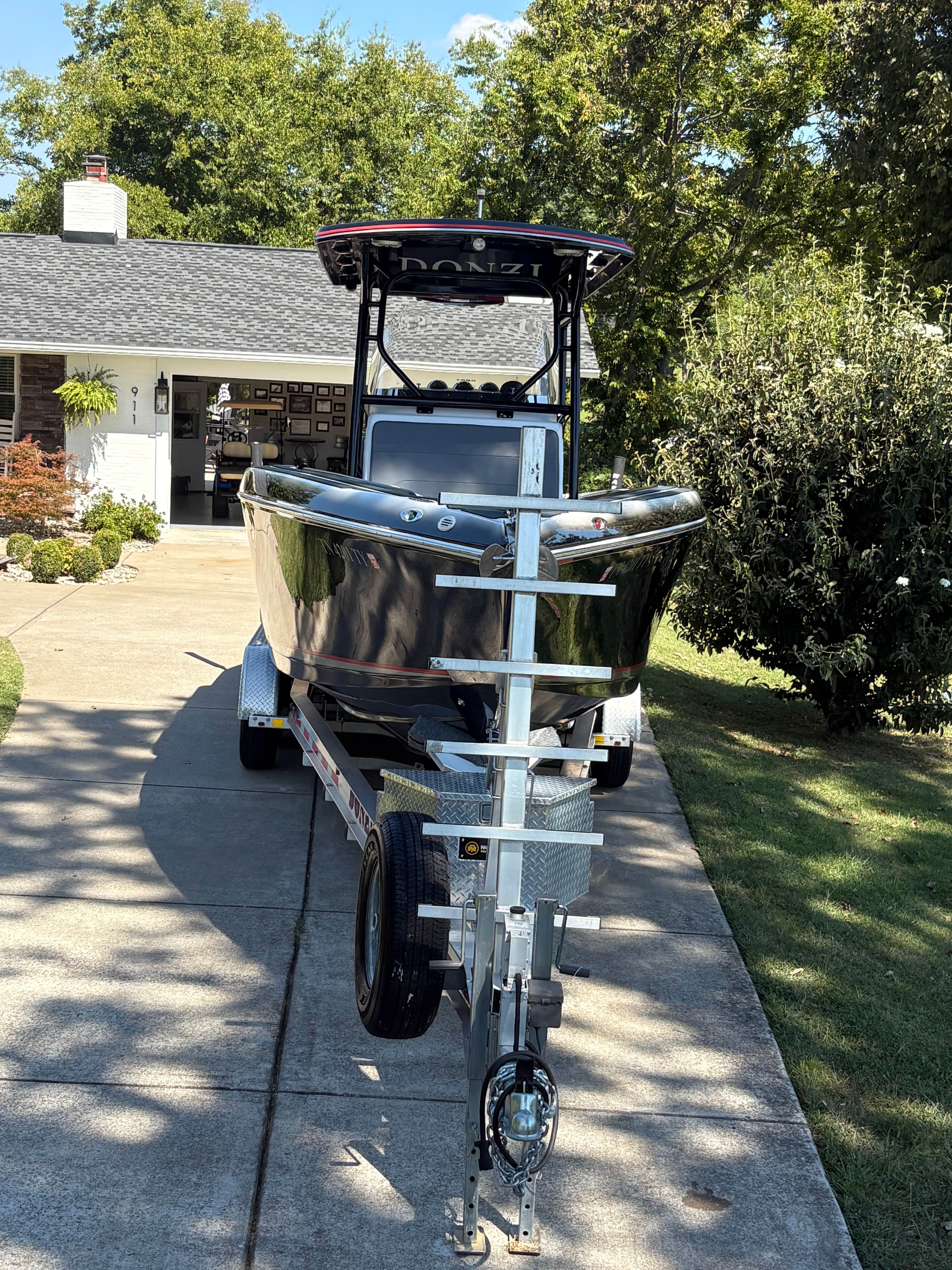 Donzi 35 ZX bow head-on view on trailer showing gleaming black hull